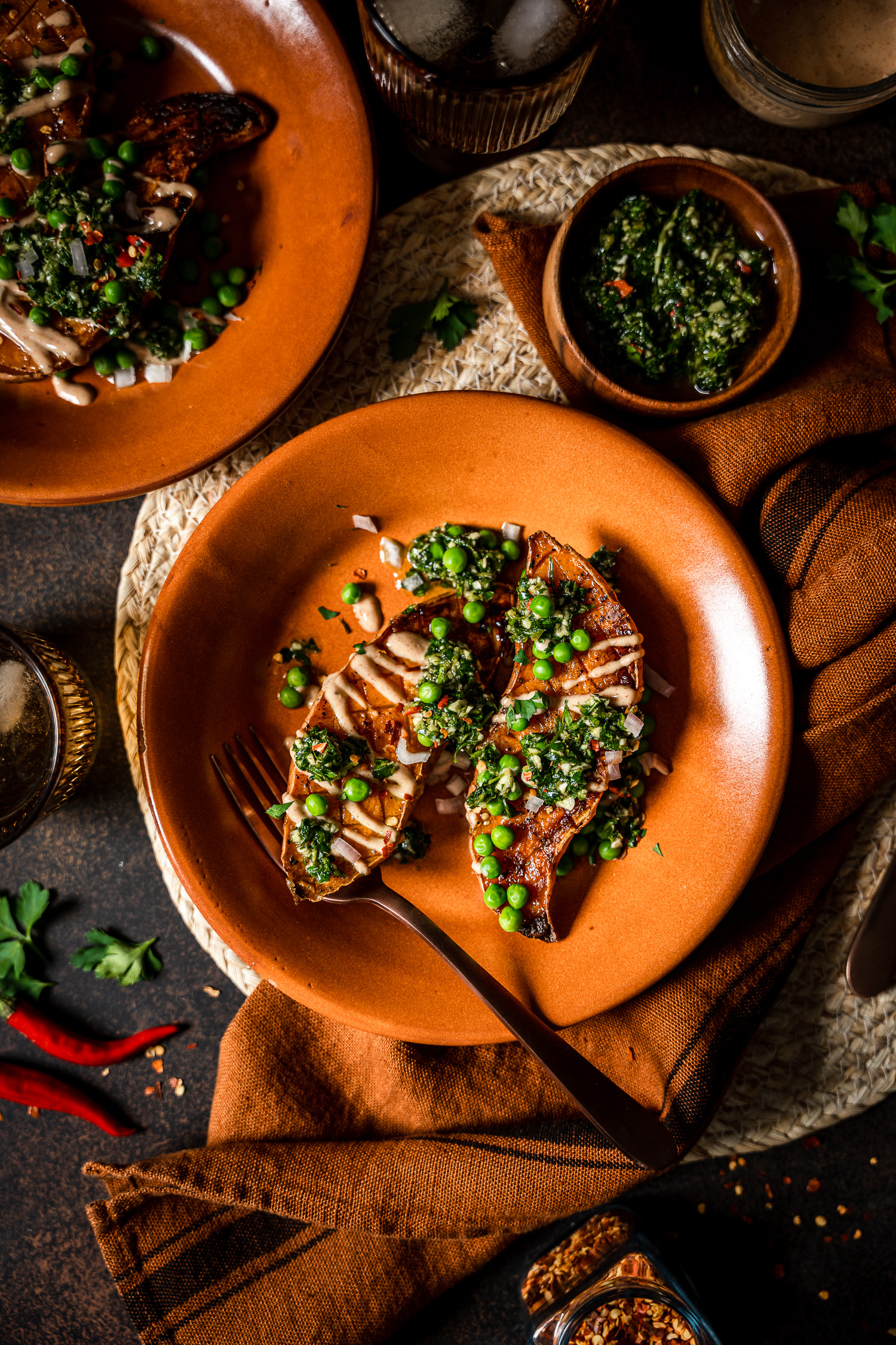 Roasted Sweet Potato Boats with Spicy Chimichurri and Smoky Crema overhead together with chimichurri in a bowl