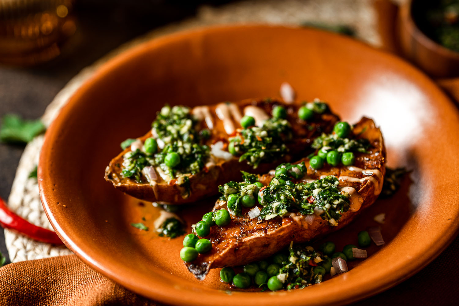 Roasted Sweet Potato Boats with Spicy Chimichurri and Smoky Crema in a plate