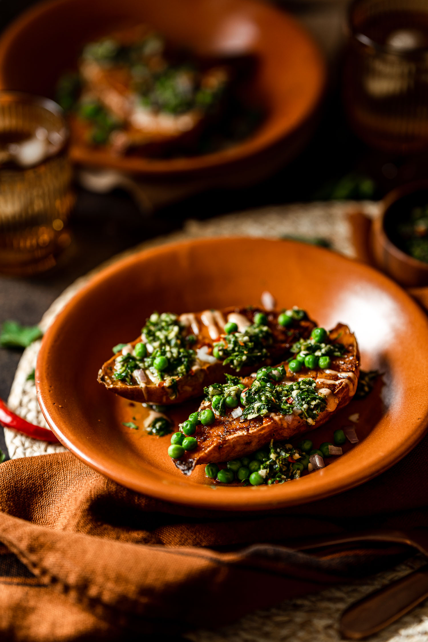 Roasted Sweet Potato Boats with Spicy Chimichurri and Smoky Crema in a plate
