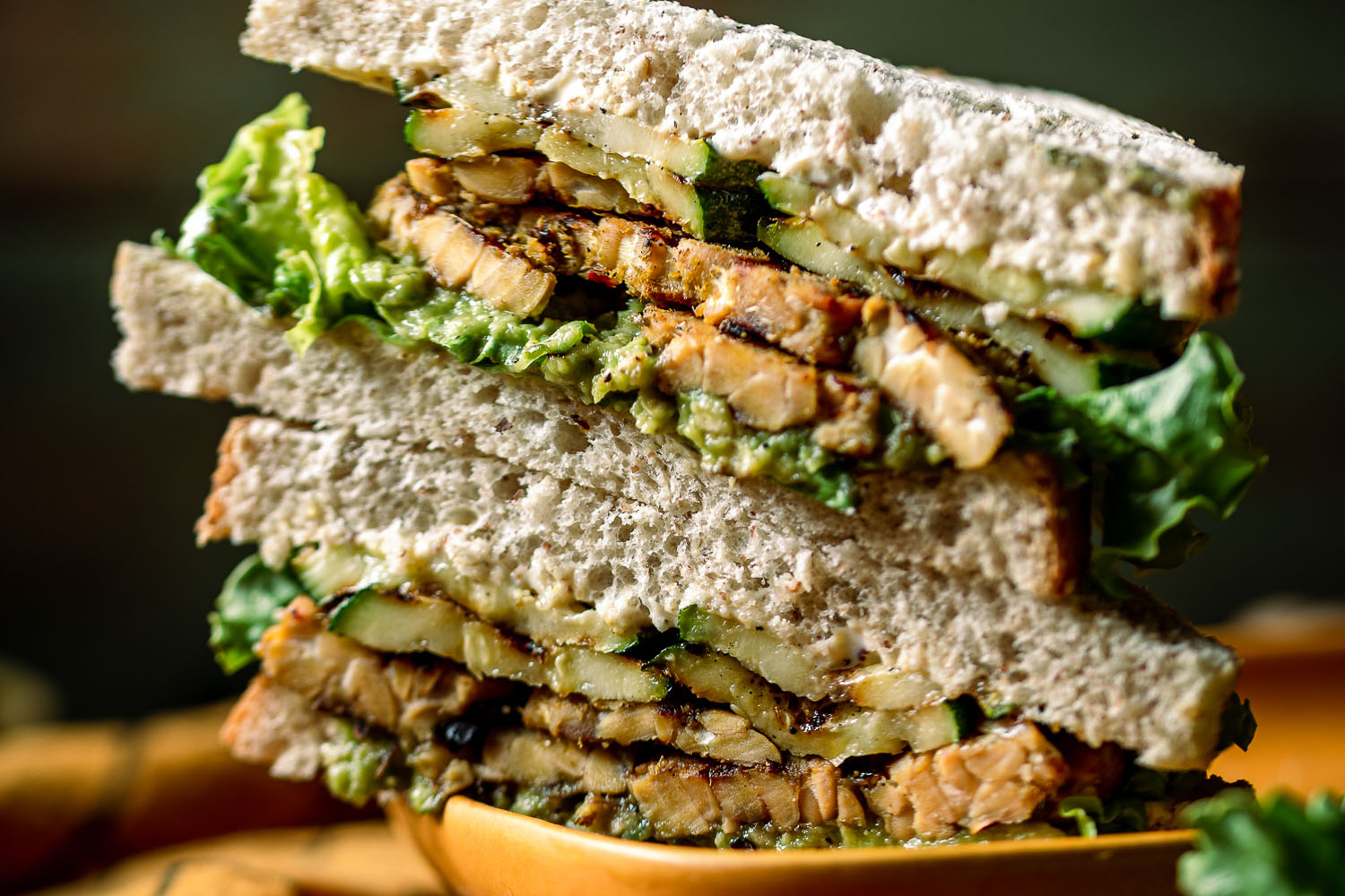 Thai Green Curry Tempeh Sandwich with Grilled Zucchini and Avocado cut in half and stacked