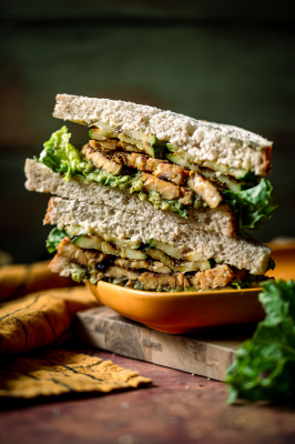 Thai Green Curry Tempeh Sandwich with Grilled Zucchini and Avocado cut in half and stacked