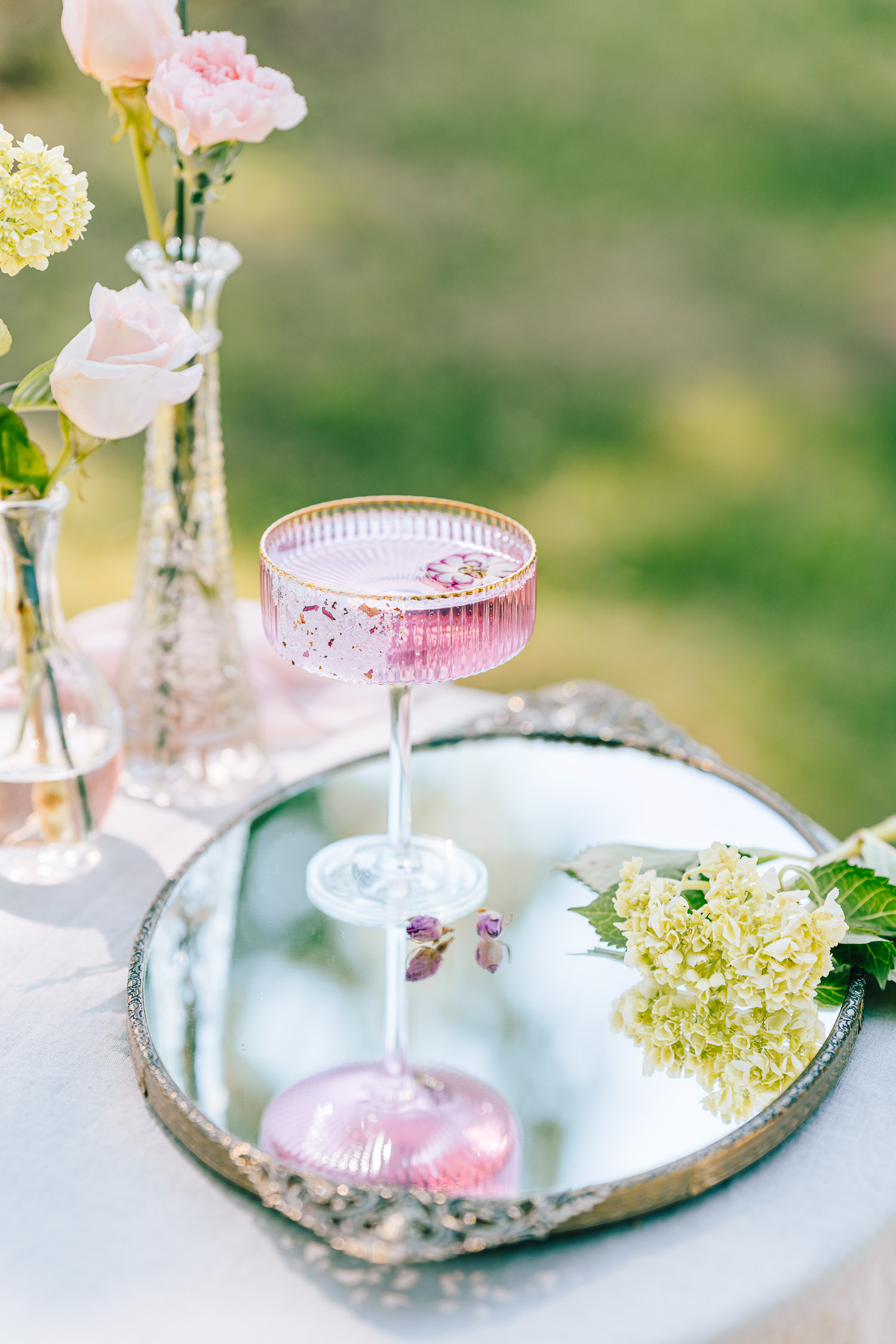 Rose Gin Tonic in a garden surrounded by flowers