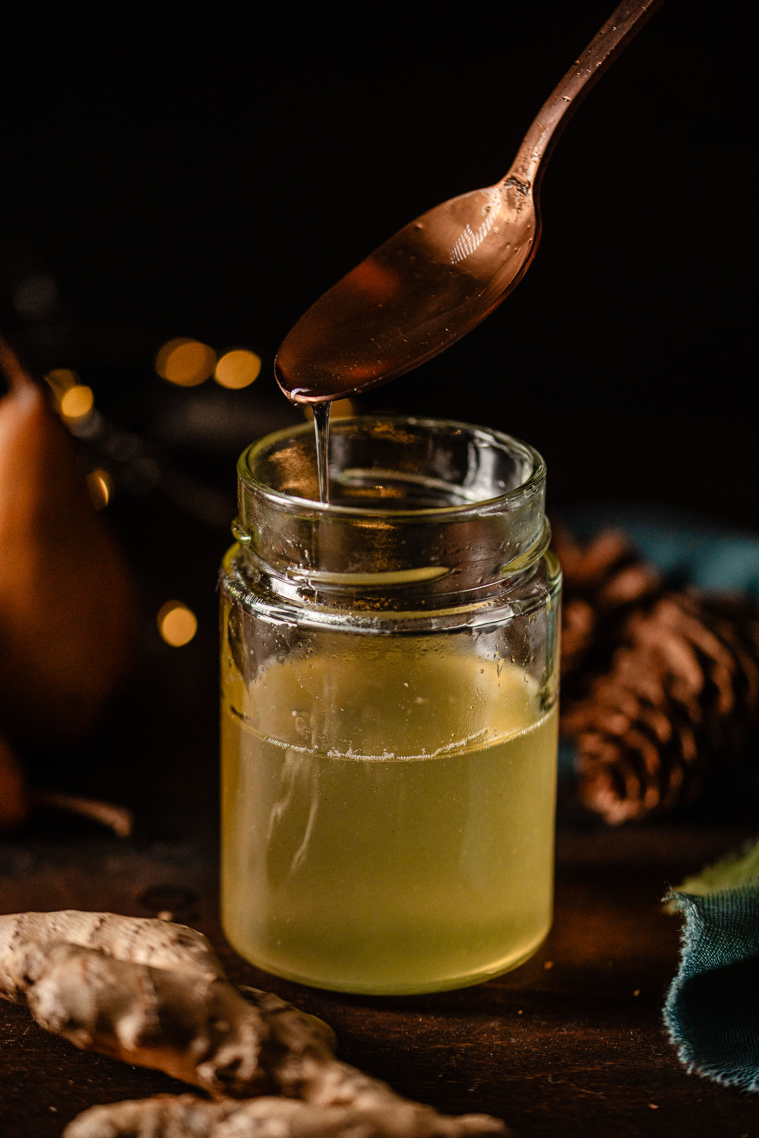 Spicy pear syrup dripping off a glass jar