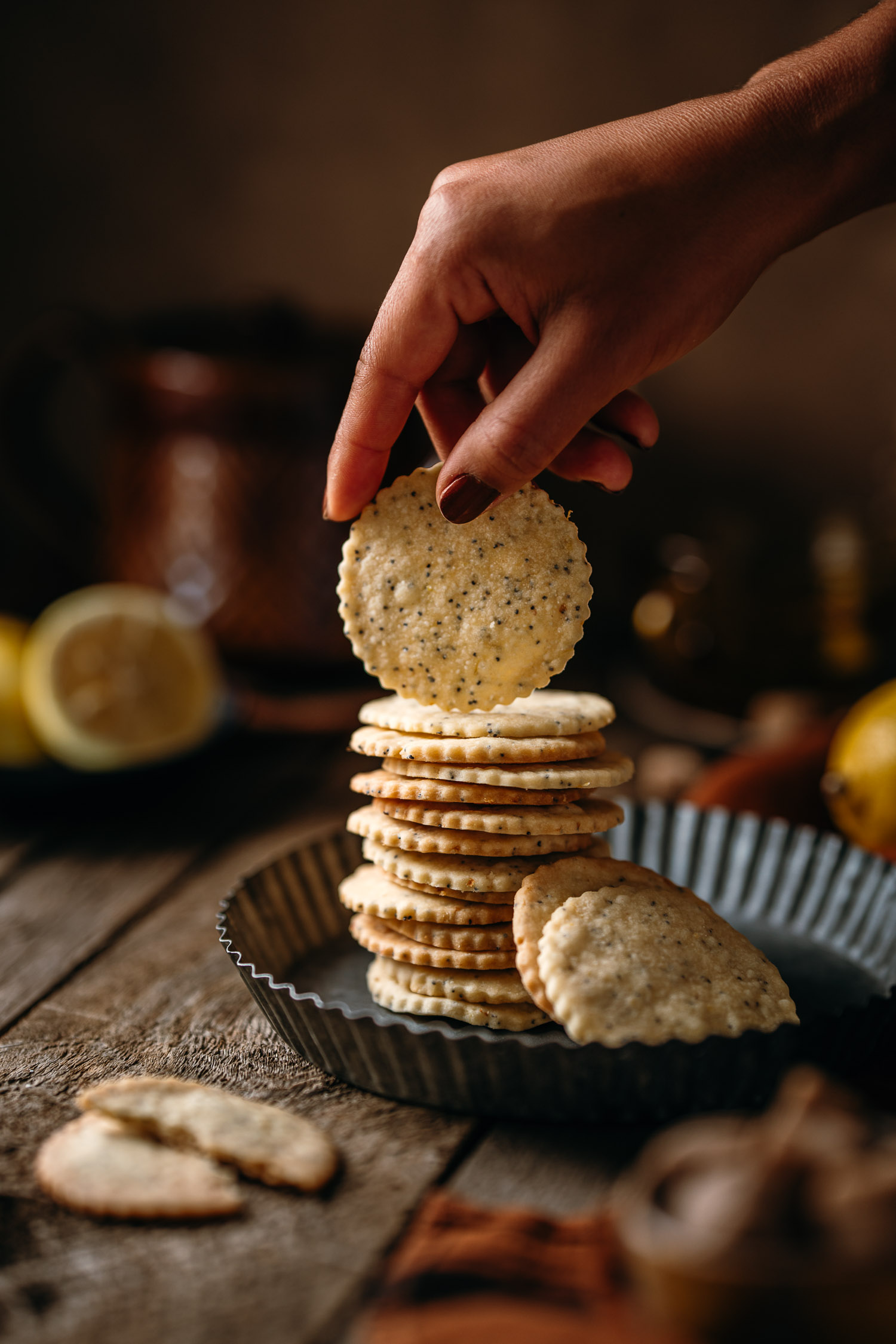 Hand holding one Lemon Poppy Seeds Shortbread Cookies