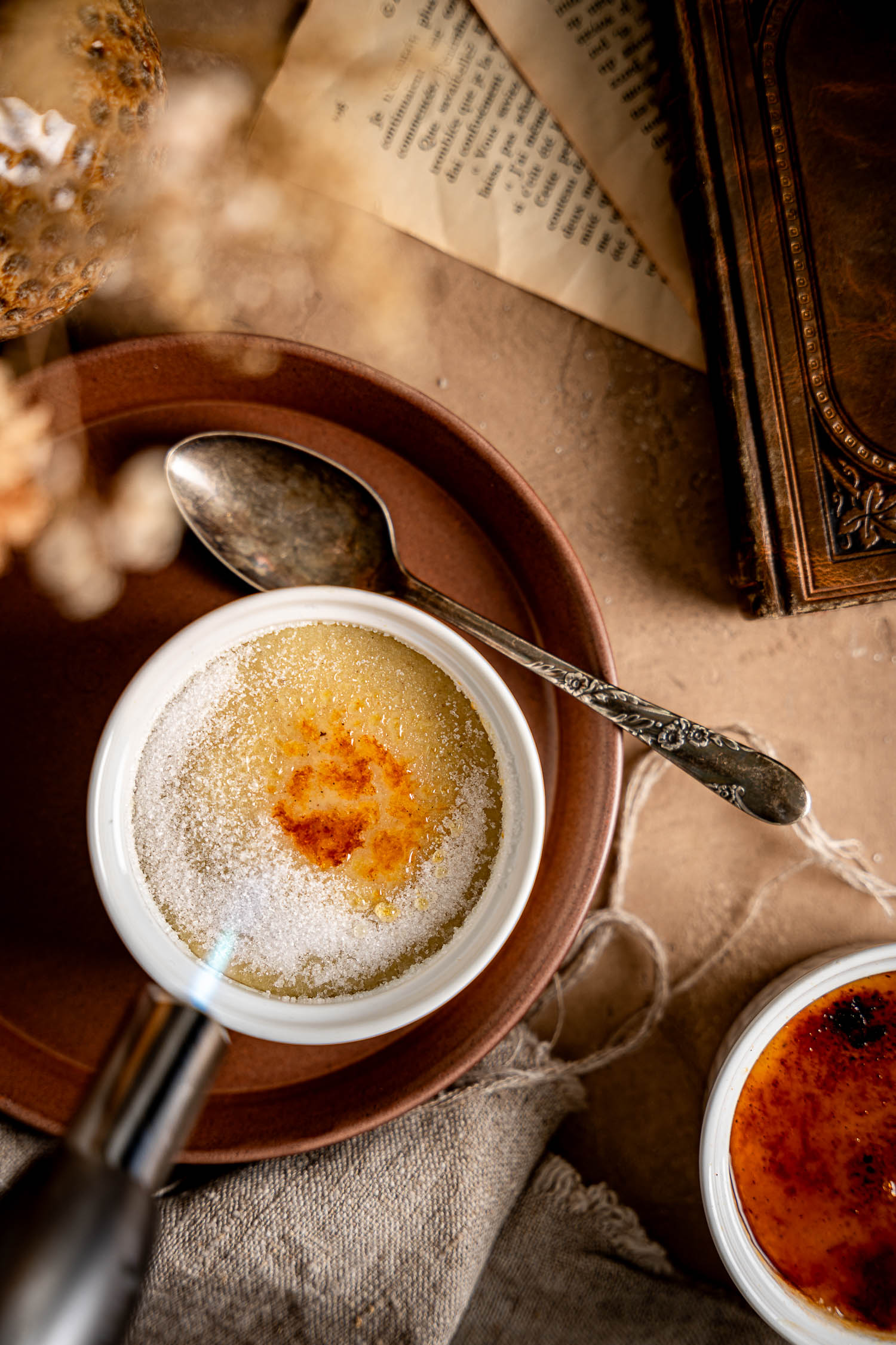 Sugar being caramelized on Vegan Vanilla-Cardamom Crème Brûlée