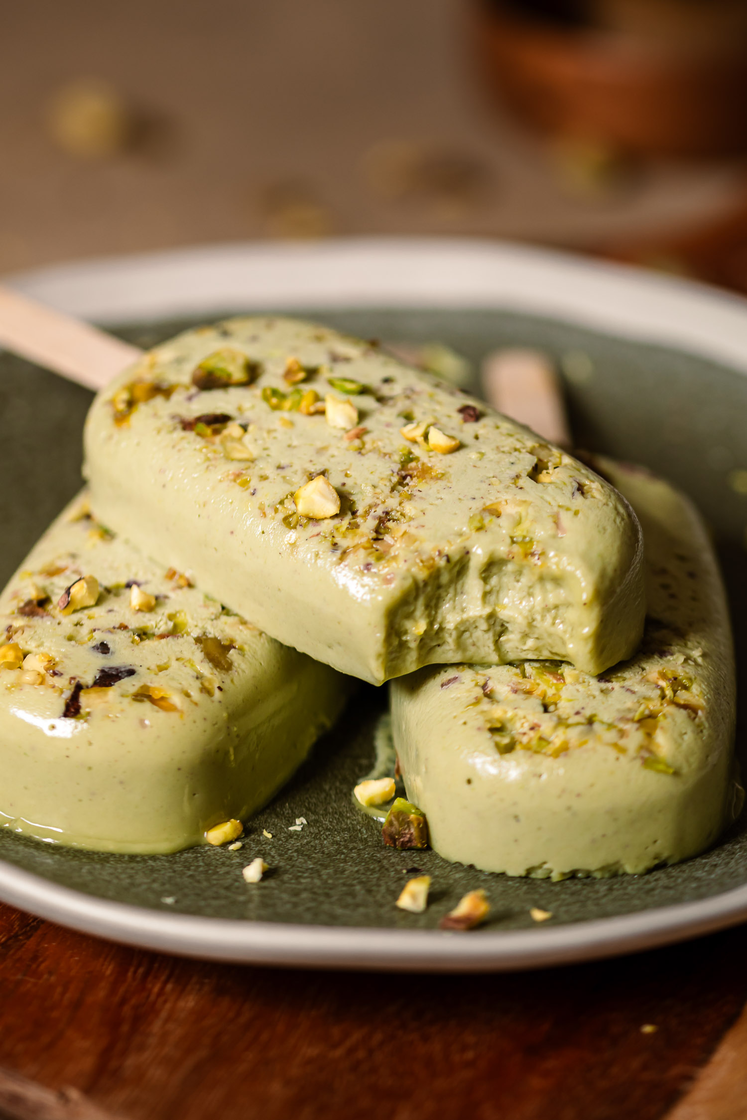 Pistachio Orange Blossom Pops with bite taken off